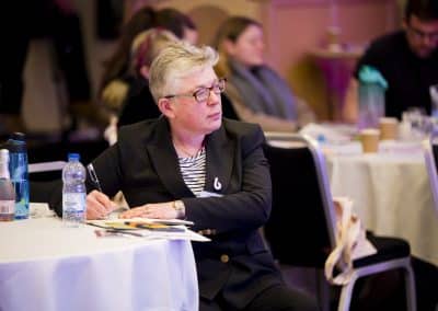 Speaker Dr Suzie Nyman writing notes on a table at the SENsible24 SENCO Conference.